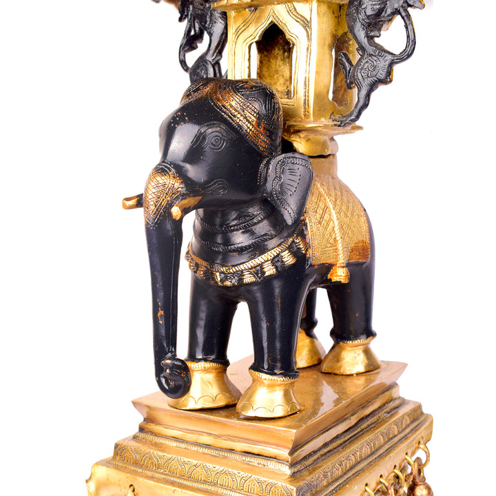 Large Brass Idol of 23 Inch Brass Chowki on Elephant with Hanging Bells. This 23 Inch Brass Chowki on Elephant with Hanging Bells is a stunning blend of artistry and tradition. Crafted from high-quality brass, the intricate detailing of the elephant and the delicately suspended bells add a touch of elegance to any space.