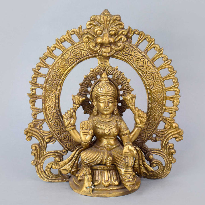 8.7 Inch Exquisite Pure Brass Goddess Lakshmi Idol with detailed Prabhaval arch, showcasing intricate craftsmanship and divine elegance for home temple or spiritual decor. No.1 Brass Idol Store www.satvikstore.in