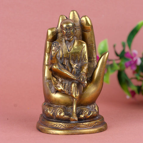 6.4 Inch Pure Brass Shirdi Sai on Hand Statue β Exquisitely Handcrafted Idol Depicting Shirdi Sai Baba Resting on a Divine Hand, Symbolizing Protection, Blessings, and Faith for Home and Temple Decor. No.1 Brass Idol Store www.satvikstore.in