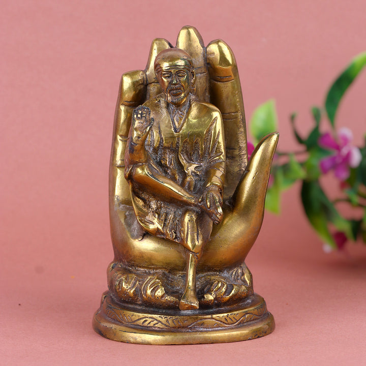 6.4 Inch Pure Brass Shirdi Sai on Hand Statue – Exquisitely Handcrafted Idol Depicting Shirdi Sai Baba Resting on a Divine Hand, Symbolizing Protection, Blessings, and Faith for Home and Temple Decor. No.1 Brass Idol Store www.satvikstore.in