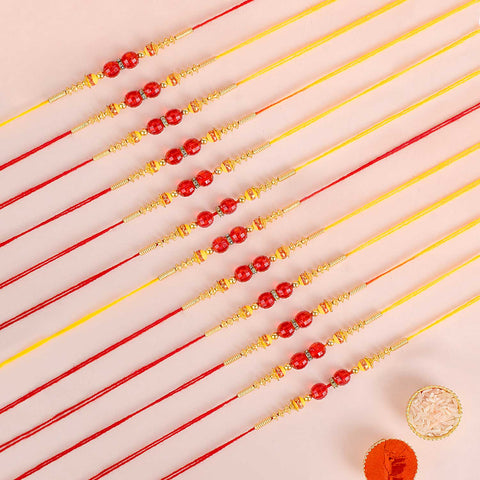 Assortment of 12 Rakhis, featuring different designs, threads, and embellishments for Raksha Bandhan. Indiaβs Largest Pooja Accessories Brand - www.satvikstore.in