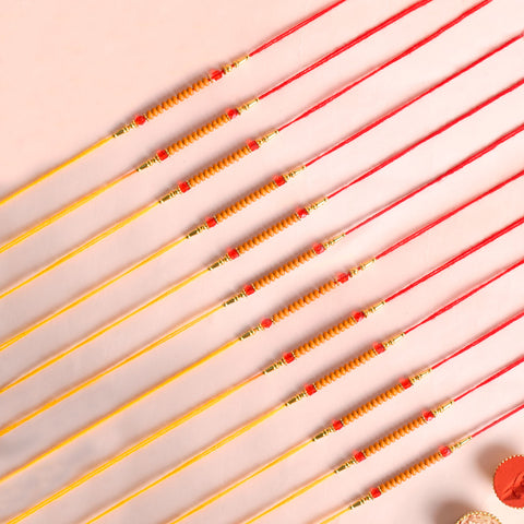 Assortment of 12 Rakhis, featuring different designs, threads, and embellishments for Raksha Bandhan. Indiaβs Largest Pooja Accessories Brand - www.satvikstore.in