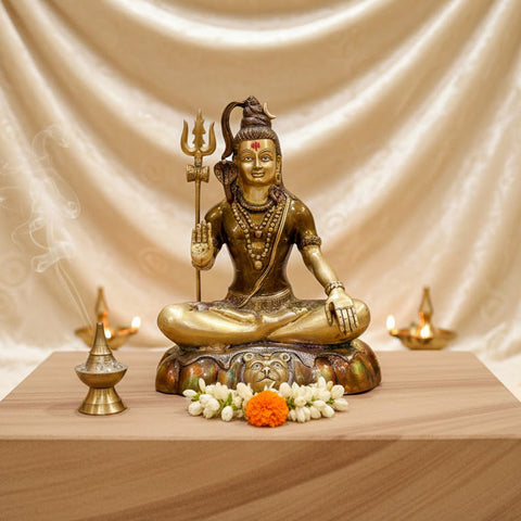  Brass Idol of 17 Inch Brass Shiva Idol in Meditative Posture. Embodying peace and spiritual focus, this 17-inch Brass Shiva Idol features Lord Shiva in a serene meditative posture. Known as the ultimate yogi, Lord Shiva is beautifully represented here with intricate detailing in brass, capturing the tranquility and profound wisdom of his meditation. India's Largest Puja Accessories Brand - Satvik No 1 Brass Idol Collection.