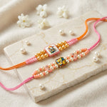 Divine Ganesha and Radha Krishna Pearl Beaded Rakhi (Set of 2)