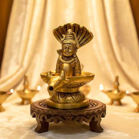 4.7 Inch Brass Shivalingam and Sheshnag Figurine showcasing Lord Shiva’s sacred lingam with the protective hood of Sheshnag — a divine symbol of power and cosmic energy. No.1 Brass Idol Store www.satvikstore.in 