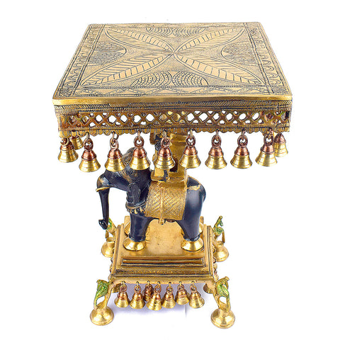  Brass Idol of 23 Inch Brass Chowki on Elephant with Hanging Bells. This 23-inch Brass Chowki on Elephant with Hanging Bells is a stunning blend of artistry and tradition. Crafted from high-quality brass, the intricate detailing of the elephant and the delicately suspended bells add a touch of elegance to any space.  India's Largest Puja Accessories Brand - Satvik