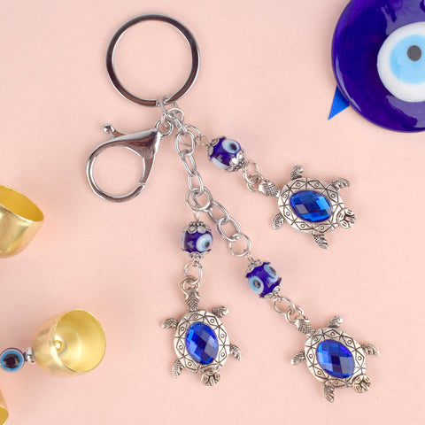 Alt Text:
Premium Stainless Steel 3 Tier Turtle Evil Eye Keychain – A durable and protective keychain with Evil Eye symbolism. India’s Largest Pooja Accessories Brand – www.satvikstore.in